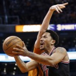 Chicago Bulls' Derrick Rose, right, is fouled by Phoenix Suns' Alex Len during the first half of an NBA basketball game Friday, Jan. 30, 2015, in Phoenix. (AP Photo/Ross D. Franklin)