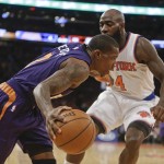 Phoenix Suns' Eric Bledsoe (2) drives past New York Knicks' Quincy Acy (4) during the first half of an NBA basketball game Saturday, Dec. 20, 2014, in New York. (AP Photo/Frank Franklin II)