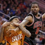 Phoenix Suns' Isaiah Thomas (3) pulls the ball away from Chicago Bulls' Aaron Brooks (0) during the first half of an NBA basketball game Friday, Jan. 30, 2015, in Phoenix. (AP Photo/Ross D. Franklin)
