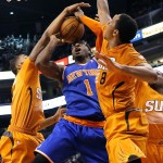  New York Knicks' Amare Stoudemire (1) has his shot blocked by Phoenix Suns' Markeiff Morris, left, and Channing Frye (8) during the first half of an NBA basketball game, Friday, March 28, 2014, in Phoenix. (AP Photo/Matt York)