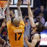 Chicago Bulls' Joakim Noah, right, moves in to block the shot of Phoenix Suns' P.J. Tucker (17) during the first half of an NBA basketball game Friday, Jan. 30, 2015, in Phoenix. (AP Photo/Ross D. Franklin)
