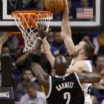 Phoenix Suns' Miles Plumlee, right, gets in front of Brooklyn Nets' Kevin Garnett (2) to get the basketball during the first half of an NBA basketball game Wednesday, Nov. 12, 2014, in Phoenix. (AP Photo/Ross D. Franklin)