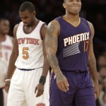 Phoenix Suns' P.J. Tucker (17) and New York Knicks' Tim Hardaway Jr. (5) react to a call during the second half of an NBA basketball game, Saturday, Dec. 20, 2014, in New York. The Suns won the game 99-90. (AP Photo/Frank Franklin II)