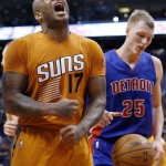 Phoenix Suns' P.J. Tucker (17) shouts after scoring as Detroit Pistons' Kyle Singler (25) reaches for the basketball during the second half of an NBA basketball game Friday, Dec. 12, 2014, in Phoenix. The Pistons defeated the Suns 105-103. (AP Photo/Ross D. Franklin)