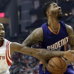 Houston Rockets' Trevor Ariza (1) tries to swat the ball away from Phoenix Suns' Markieff Morris (11) in the first half of an NBA basketball game Saturday, Dec. 6, 2014, in Houston. (AP Photo/Pat Sullivan)