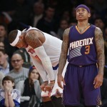 Phoenix Suns' Isaiah Thomas (3) and New York Knicks' Carmelo Anthony (7) react during the second half of an NBA basketball game Saturday, Dec. 20, 2014, in New York. The Suns won the game 99-90. (AP Photo/Frank Franklin II)