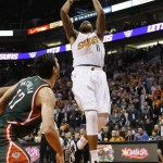 Phoenix Suns' Markieff Morris (11) shoots over Milwaukee Bucks' Zaza Pachulia, of Georgia, during the second half of an NBA basketball game, Monday, Dec. 15, 2014, in Phoenix. The Bucks won 96-94. (AP Photo/Matt York)