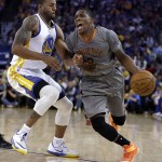 Phoenix Suns' Eric Bledsoe, right, drives the ball against Golden State Warriors' Andre Iguodala during the first half of an NBA basketball game Thursday, April 2, 2015, in Oakland, Calif. (AP Photo/Ben Margot)