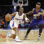Los Angeles Clippers' Chris Paul, left, controls the ball against Phoenix Suns' Isaiah Thomas during the second half of an NBA basketball game Saturday, Nov. 15, 2014, in Los Angeles. The Clippers won 120-107. (AP Photo/Danny Moloshok)