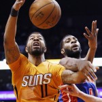 Phoenix Suns' Markieff Morris (11) battles for a rebound with Detroit Pistons' Andre Drummond, right, during the first half of an NBA basketball game Friday, Dec. 12, 2014, in Phoenix. (AP Photo/Ross D. Franklin)