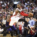 Toronto Raptors' Terrence Ross, right, leaps to save the ball from going out of bounds in front of Phoenix Suns' P.J. Tucker during the second half of an NBA basketball game in Toronto on Monday, Nov. 24, 2014. (AP Photo/The Canadian Press, Darren Calabrese)