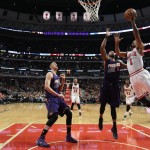 Chicago Bulls guard Derrick Rose (1) goes in for a lay up past Phoenix Suns forward Markieff Morris (11) during the second half of an NBA basketball game in Chicago, on Saturday, Feb. 21, 2015. The Bulls won the game 112-107. (AP Photo/Jeff Haynes)