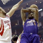 Houston Rockets' James Harden (13) steals the ball from Phoenix Suns' Markieff Morris (11) as Donatas Motiejunas (20) reaches in to block in the first half of an NBA basketball game Saturday, Dec. 6, 2014, in Houston. (AP Photo/Pat Sullivan)
