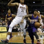 Phoenix Suns' Isaiah Thomas is fouled as he tries to drive past Milwaukee Bucks' John Henson (31) during the second half of an NBA basketball game Tuesday, Jan. 6, 2015, in Milwaukee. The Suns won 102-96. (AP Photo/Morry Gash)