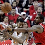 Portland Trail Blazers forward LaMarcus Aldridge, right, knocks the ball out of the hands of Phoenix Suns forward Markieff Morris during the second half of an NBA basketball game in Portland, Ore., Thursday, Feb. 5, 2015. The Trail Blazers won 108-87. (AP Photo/Don Ryan)