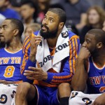 New York Knicks' J.R. Smith, Tyson Chandler and Raymond Felton, from left, watch the final minute against the Phoenix Suns form the bench during an NBA basketball game, Friday, March 28, 2014, in Phoenix. The Suns won 112-88. (AP Photo/Matt York)