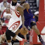 Houston Rockets' James Harden (13) works to maintain control of the ball under pressure from Phoenix Suns' P.J. Tucker in the first half of an NBA basketball game Saturday, Dec. 6, 2014, in Houston. (AP Photo/Pat Sullivan)