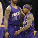 Phoenix Suns' Markieff Morris (11) talks with Isaiah Thomas (3) after receiving his second technical foul and being ejected during the second half of an NBA basketball game against the Charlotte Hornets in Charlotte, N.C., Wednesday, Dec. 17, 2014. The Suns won 111-106. (AP Photo/Chuck Burton)