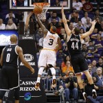 Phoenix Suns' Isaiah Thomas (3) drives past Brooklyn Nets' Bojan Bogdanovic (44), of Croatia, and Jarrett Jack (0) during the first half of an NBA basketball game Wednesday, Nov. 12, 2014, in Phoenix. (AP Photo/Ross D. Franklin)