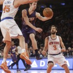 Phoenix Suns' Goran Dragic (1), of Slovenia, passes away from New York Knicks' Cole Aldrich (45) and Jose Calderon (3), of Spain, during the first half of an NBA basketball game Saturday, Dec. 20, 2014, in New York. (AP Photo/Frank Franklin II)