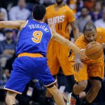 New York Knicks' Pablo Prigioni (9) and Phoenix Suns' P.J. Tucker chase down a loose ball during the second half of an NBA basketball game, Friday, March 28, 2014, in Phoenix. (AP Photo/Matt York)