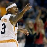 Phoenix Suns guard Isaiah Thomas points to a teammate after scoring during the first half of an NBA basketball game against the Memphis Grizzlies, Wednesday, Nov. 5, 2014, in Phoenix. (AP Photo/Matt York)