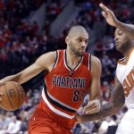 Portland Trail Blazers forward Nicolas Batum, from France, drives on Phoenix Suns forward P.J. Tucker during the second half of an NBA basketball game in Portland, Ore., Thursday, Feb. 5, 2015. Batum topped the Trail Blazers with 20 points as they defeated the Suns 108-87. (AP Photo/Don Ryan)