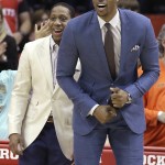Injured Houston Rockets players Isaiah Canaan, right, and Dwight Howard cheer on their teammates in the second half of an NBA basketball game against the Phoenix Suns Saturday, Dec. 6, 2014, in Houston. The Rockets won 100-95. (AP Photo/Pat Sullivan)