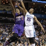 Phoenix Suns' Eric Bledsoe (2) drives past Charlotte Hornets' Kemba Walker (15) during the second half of an NBA basketball game in Charlotte, N.C., Wednesday, Dec. 17, 2014. The Suns won 111-106. (AP Photo/Chuck Burton)
