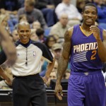 Phoenix Suns guard Eric Bledsoe (2) laughs after talking with referee Sean Corbin, left, during the third quarter of an NBA basketball game against the Minnesota Timberwolves in Minneapolis, Sunday, March 23, 2014. The Suns won 127-120. (AP Photo/Ann Heisenfelt)