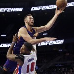 Detroit Pistons forward Greg Monroe (10) is fouled by Phoenix Suns center Miles Plumlee (22) during the second half of an NBA basketball game in Auburn Hills, Mich., Wednesday, Nov. 19, 2014. (AP Photo/Carlos Osorio)
