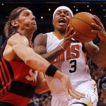 Phoenix Suns guard Isaiah Thomas (3) gets fouled by Flamengo forward Walter Herrmann (1) of Argentina, in the second quarter during an NBA preseason basketball game, Wednesday, Oct. 8, 2014, in Phoenix. (AP Photo/Rick Scuteri)