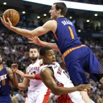 Toronto Raptors' Kyle Lowry, second from right, draws an offensive foul on a leaping Phoenix Suns' Goran Dragic during the second half of an NBA basketball game in Toronto on Monday, Nov. 24, 2014. (AP Photo/The Canadian Press, Darren Calabrese)