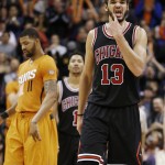 Chicago Bulls' Joakim Noah (13) and Derrick Rose (1) walk down the court after Phoenix Suns' Markieff Morris (11) was fouled during the second half of an NBA basketball game Friday, Jan. 30, 2015, in Phoenix. The Suns defeated the Bulls 99-93. (AP Photo/Ross D. Franklin)