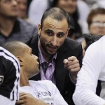 San Antonio Spurs guard Manu Ginobili, rear, of Argentina, talks to Spurs' Patty Mills, of Australia, during the first half of an NBA basketball game against the Phoenix Suns on Friday, April 11, 2014, in San Antonio. (AP Photo/Darren Abate)
