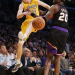 Los Angeles Lakers' Steve Blake, left, tries to save a ball from going out of bounds as Phoenix Suns' Jermaine O'Neal, right, defends during the first half of an NBA basketball game, Tuesday, Feb. 12, 2013, in Los Angeles. (AP Photo/Danny Moloshok)
