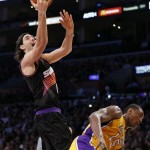 Phoenix Suns' Luis Scola, of Argentina, left, goes to the hoop over against Los Angeles Lakers' Metta World Peace during the first half of an NBA basketball game on Tuesday, Feb. 12, 2013, in Los Angeles. The Lakers won 91-85. (AP Photo/Danny Moloshok)