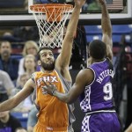 Phoenix Suns center Hamed Haddadi, left, tries to block the shoot of Sacramento Kings forward Patrick Patterson during the first quarter of an NBA basketball game in Sacramento, Calif., Friday, March 8, 2013. (AP Photo/Rich Pedroncelli)