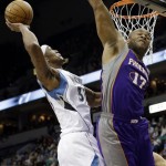 
Minnesota Timberwolves' Dante Cunningham, left, lays up a shot as Phoenix Suns' P.J. Tucker defends in the first quarter of an NBA basketball game on Saturday, April 13, 2013, in Minneapolis. (AP Photo/Jim Mone)
