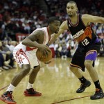 Houston Rockets' Aaron Brooks, left, drives around Phoenix Suns' Kendall Marshall (12) during the fourth quarter of an NBA basketball game Wednesday, March 13, 2013, in Houston. (AP Photo/David J. Phillip)