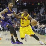 Cleveland Cavaliers' Dion Waiters (3) loses the ball under pressure from Phoenix Suns' Markieff Morris in the second quarter of an NBA basketball game, Sunday, Jan. 26, 2014, in Cleveland. (AP Photo/Mark Duncan)