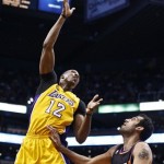 Los Angeles Lakers' Dwight Howard (12) gets off a shot over Phoenix Suns' Hamed Haddadi (98), of Iran, in the first half of an NBA basketball game on Monday, March 18, 2013, in Phoenix. (AP Photo/Ross D. Franklin)