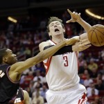Houston Rockets' Omer Asik has the ball knocked away by Phoenix Suns' Wesley Johnson (2) during the third quarter of an NBA basketball game Wednesday, March 13, 2013, in Houston. (AP Photo/David J. Phillip)