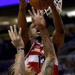 Washington Wizards' Kevin Seraphin (13) pulls down a rebound over Phoenix Suns' Michael Beasley during the first half of an NBA basketball game on Wednesday, March 20, 2013, in Phoenix. (AP Photo/Matt York)