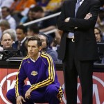 Los Angeles Lakers' Steve Nash, left, waits to go in the game as head coach Mike D'Antoni stands next to him in the first half of an NBA basketball game against the Phoenix Suns on Monday, March 18, 2013, in Phoenix. (AP Photo/Ross D. Franklin)