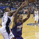 Phoenix Suns' Channing Frye, right, goes after a rebound in front of Orlando Magic's Maurice Harkless during the first half of an NBA basketball game in Orlando, Fla., Sunday, Nov. 24, 2013. (AP Photo/John Raoux)