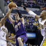 Phoenix Suns guard Goran Dragic, center, shoots between Indiana Pacers guard George Hill, left, and forward David West in the first half of an NBA basketball game in Indianapolis, Thursday, Jan. 30, 2014. (AP Photo)

