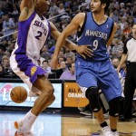 Minnesota Timberwolves' Ricky Rubio (9), of Spain, passes behind the back of Phoenix Suns' Wesley Johnson (2) during the first half of an NBA basketball game on Friday, March 22, 2013, in Phoenix. (AP Photo/Matt York)