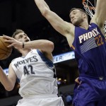  Minnesota Timberwolves' Kevin Love eyes a possible shot as Phoenix Suns' Miles Plumlee defends in the first quarter of an NBA basketball game on Wednesday, Jan. 8, 2014, in Minneapolis. (AP Photo/Jim Mone)