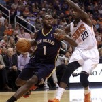 New Orleans Pelicans point guard Tyreke Evans (1) drives on Phoenix Suns shooting guard Archie Goodwin (20) in the second quarter during an NBA basketball game on Sunday, Nov. 10, 2013, in Phoenix. (AP Photo/Rick Scuteri)